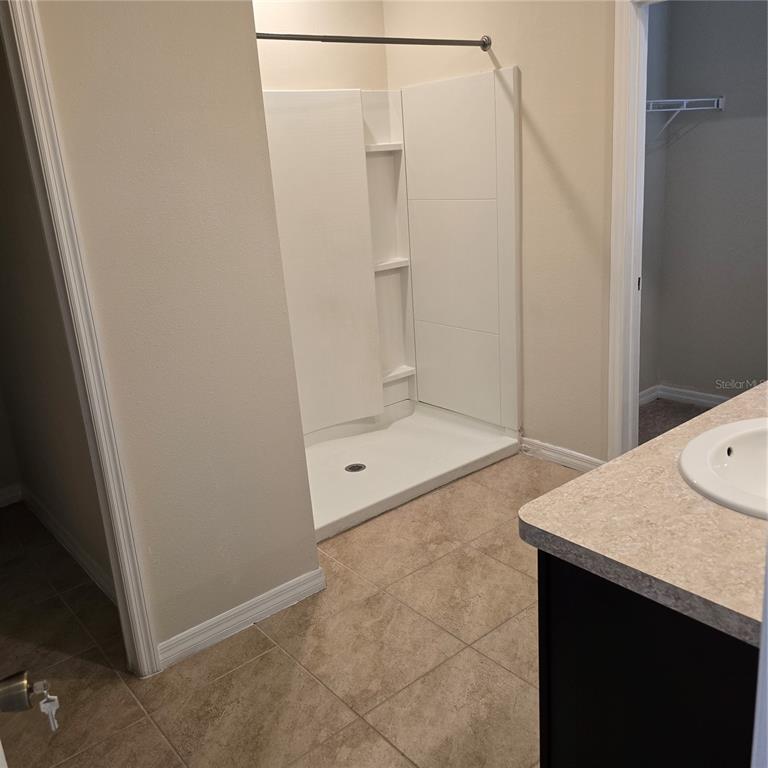 814 Sun Burst Road Winter Haven, FL 33880 - Photo 24 of 48 a bathroom with a granite countertop sink and shower
