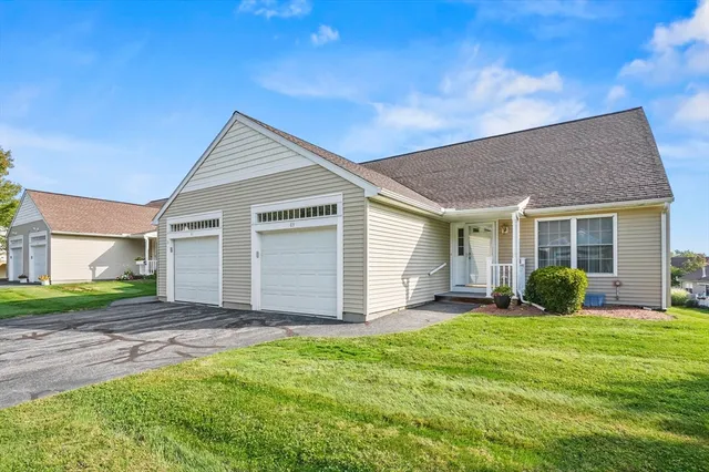 a front view of a house with a yard and table