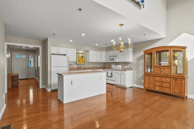 a kitchen with a refrigerator and a stove top oven