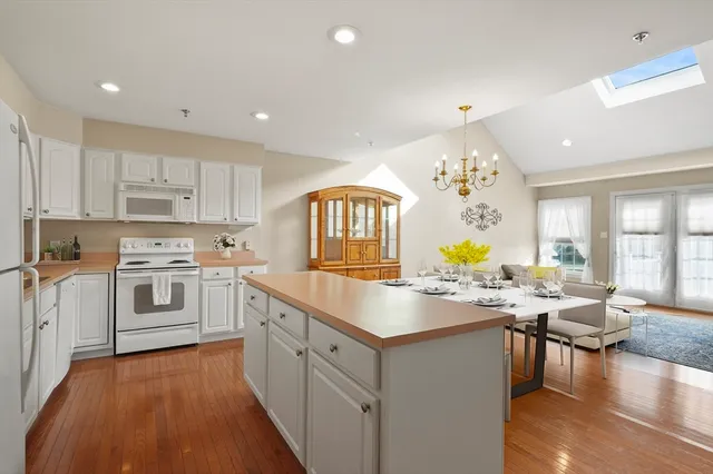 a kitchen with granite countertop a sink stove and cabinets