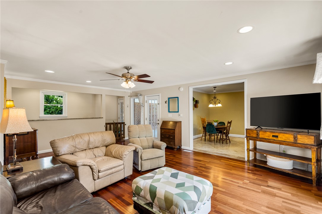 512 East Fredericks Street Anderson, SC 29621 - Photo 7 of 31 Rich hardwood flooring stretches across a welcoming living area, connected to a dedicated dining space.