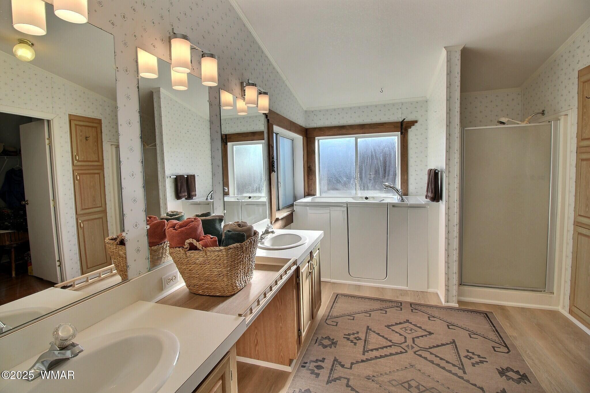 4134 Porter Mountain Road Lakeside, AZ 85929 - Photo 12 of 43 The large bathroom has been upgraded with a sit in bathtub. The space has double vanities and a shower area is also available.