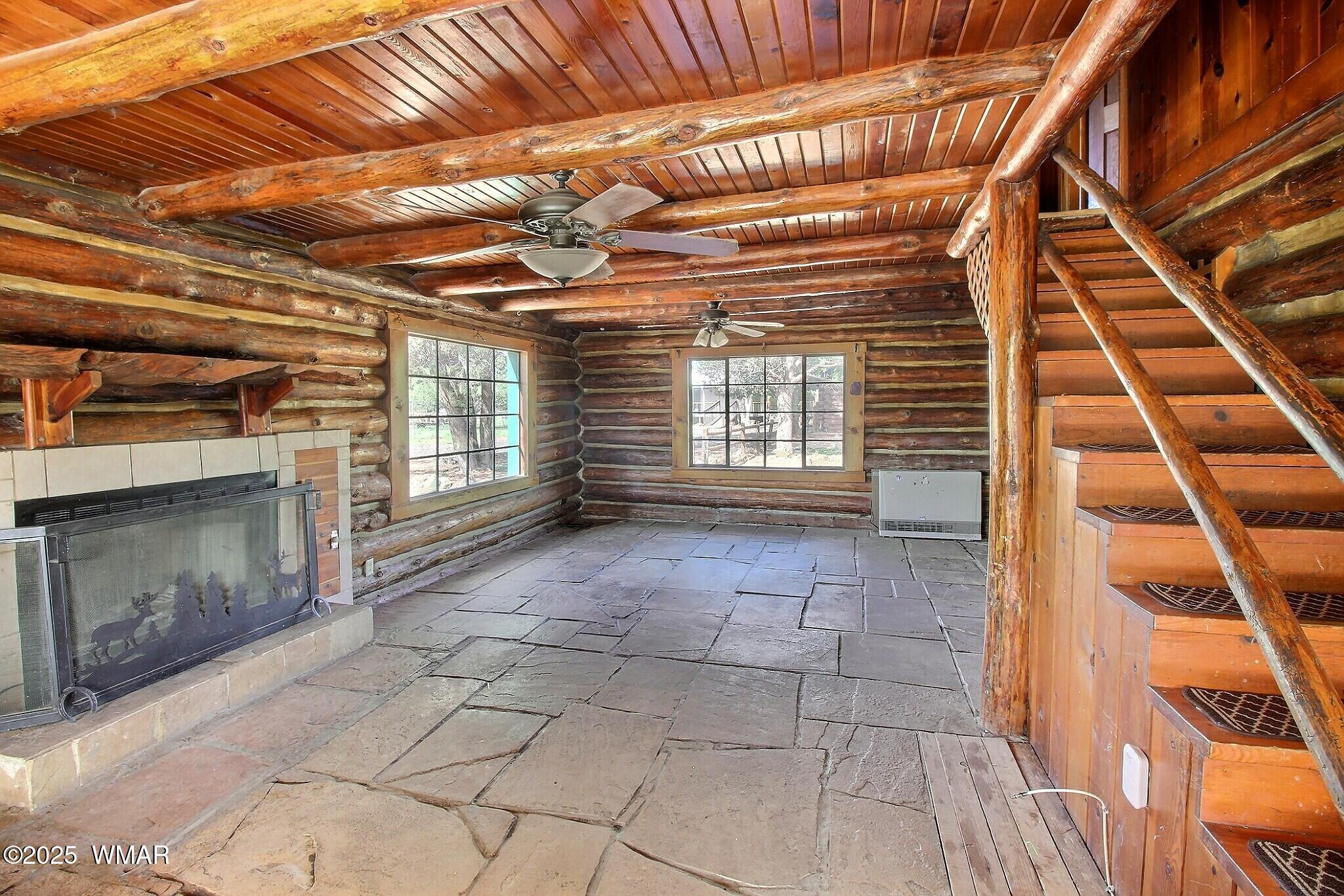4134 Porter Mountain Road Lakeside, AZ 85929 - Photo 30 of 43 A long with beautiful patinaed logs, the cabin also features native stone flooring and a large wood fireplace.