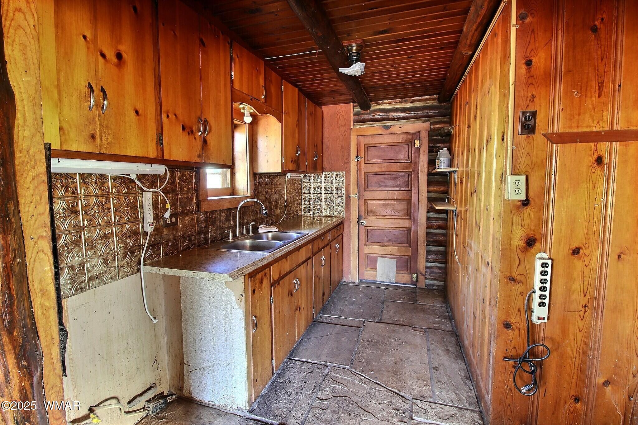 4134 Porter Mountain Road Lakeside, AZ 85929 - Photo 31 of 43 A galley kitchen leads to a utility room with a laundry area.