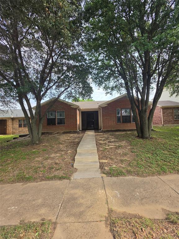 725 Trinity Lane Dallas, TX 75241 - Photo 1 of 10 a front view of a house with a garden