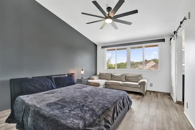 a bedroom with a large bed and a couch