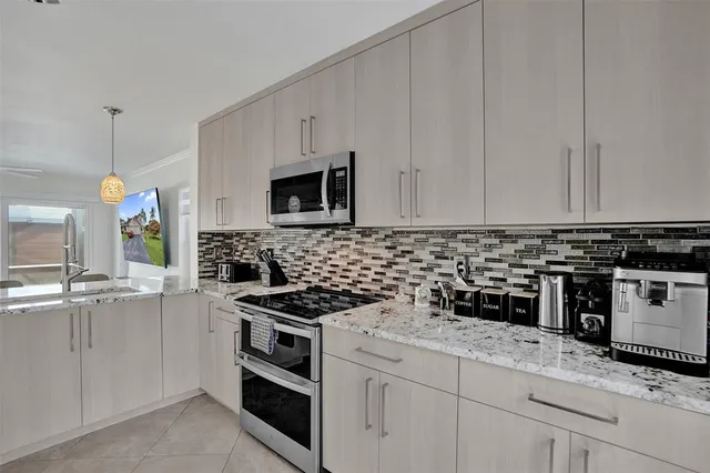 a kitchen with cabinets appliances and a sink
