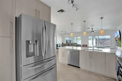 a kitchen with stainless steel appliances a refrigerator and a stove