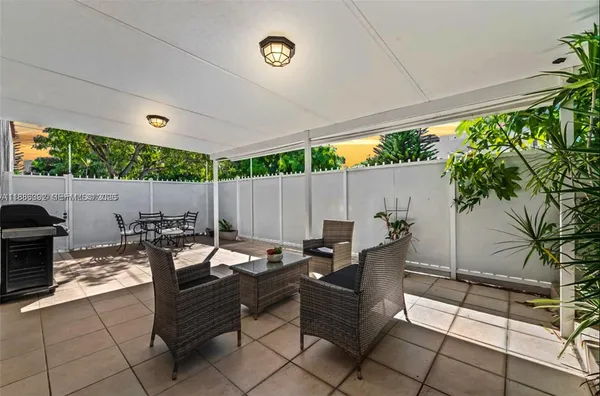 a outdoor space with lots of tables a garden and a couch