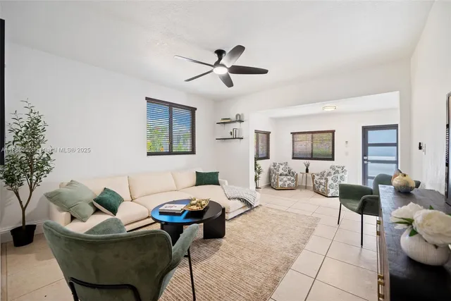a living room with furniture and a ceiling fan