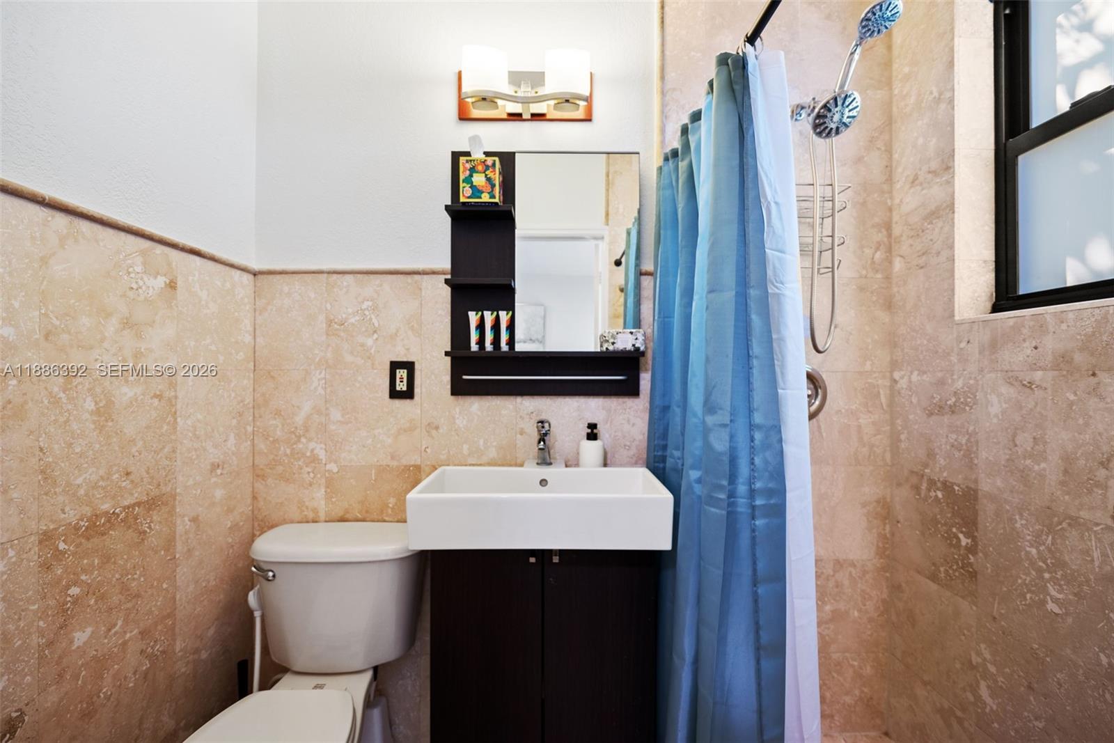 944 Southwest 10th Avenue Miami, FL 33130 - Photo 14 of 30 a bathroom with a sink mirror toilet and shower