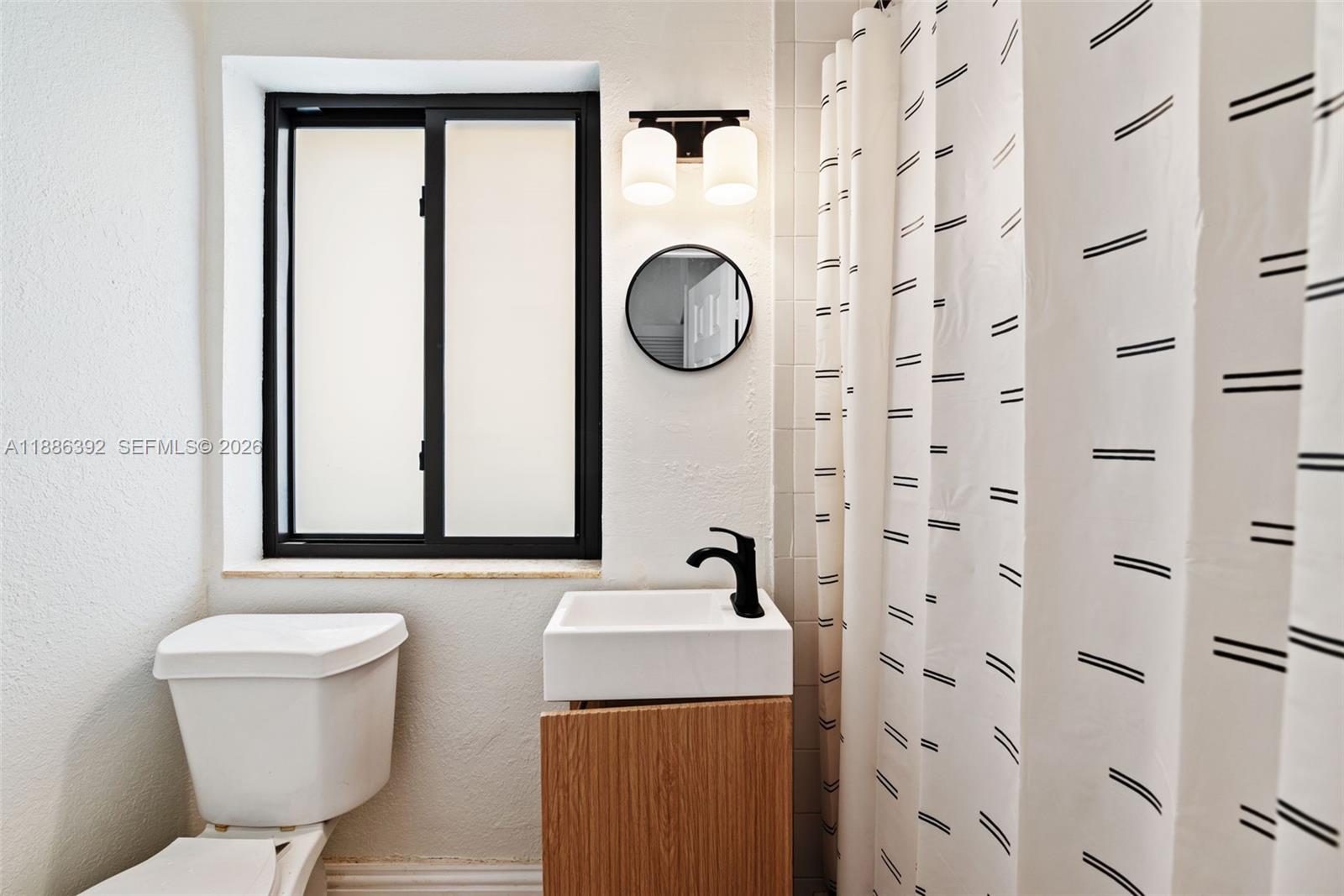 944 Southwest 10th Avenue Miami, FL 33130 - Photo 15 of 30 a bathroom with a toilet sink and mirror