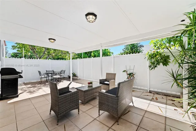a outdoor space with lots of tables a garden and a couch