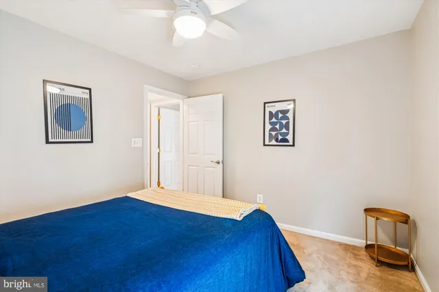 a bedroom with a bed and a painting on the wall