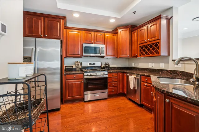 a kitchen with stainless steel appliances granite countertop a stove top oven a sink and dishwasher