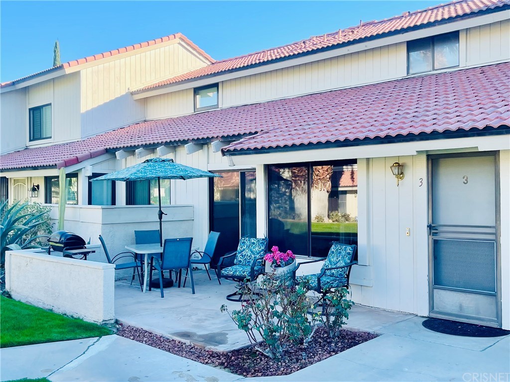 a front view of a house with sitting area