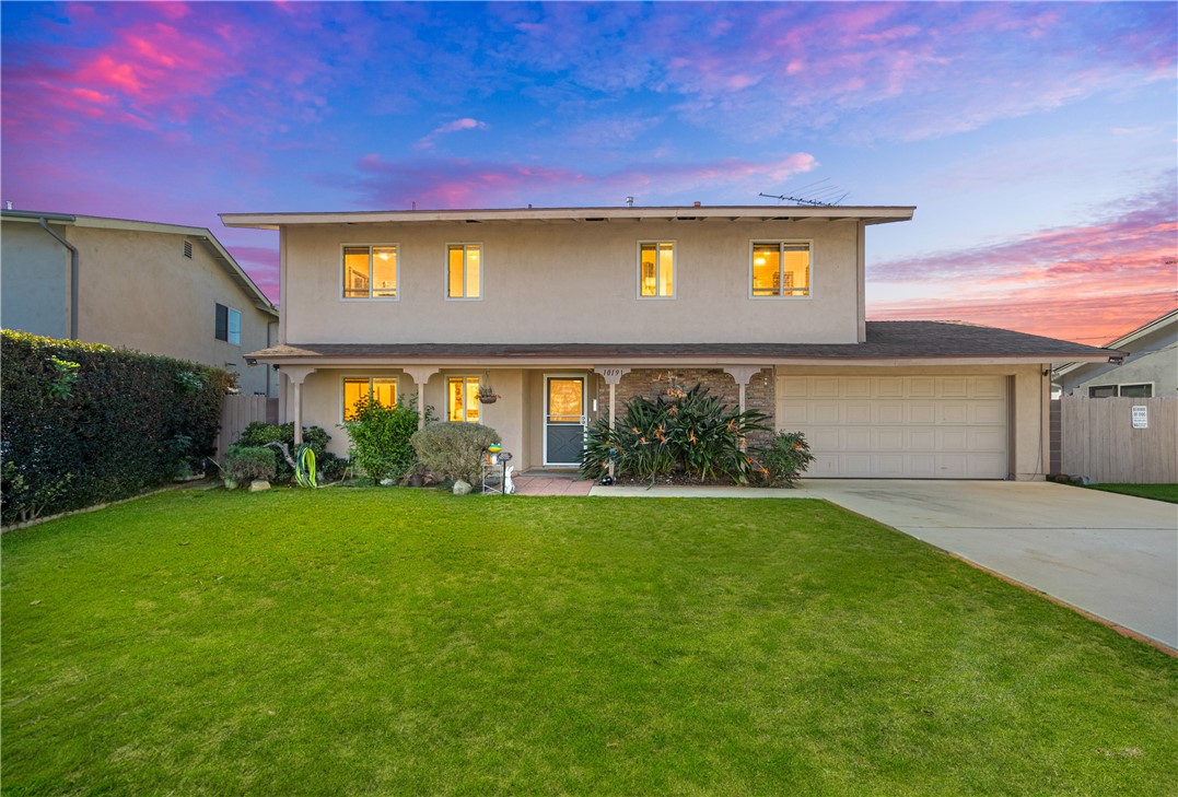 10191 Virgil Circle Cypress, CA 90630 - Photo 1 of 53 a front view of a house with a garden and yard