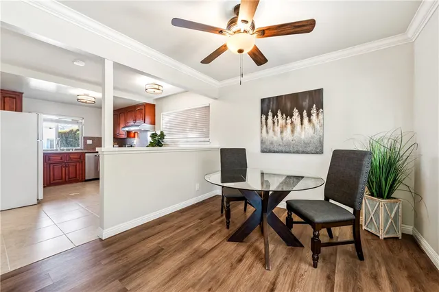 a kitchen with a table chairs a sink and dishwasher