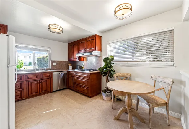 a kitchen with stainless steel appliances a stove a sink and a microwave