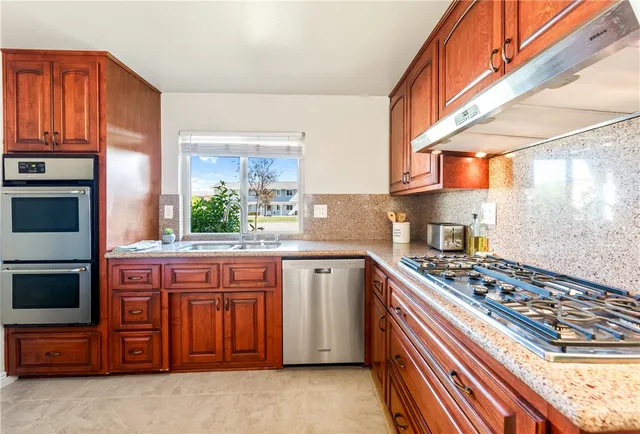 a kitchen with a sink stove and cabinets