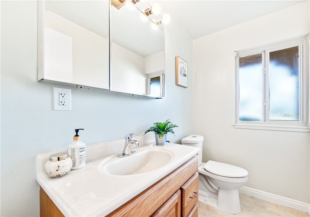 10191 Virgil Circle Cypress, CA 90630 - Photo 18 of 53 a bathroom with a sink toilet and a mirror