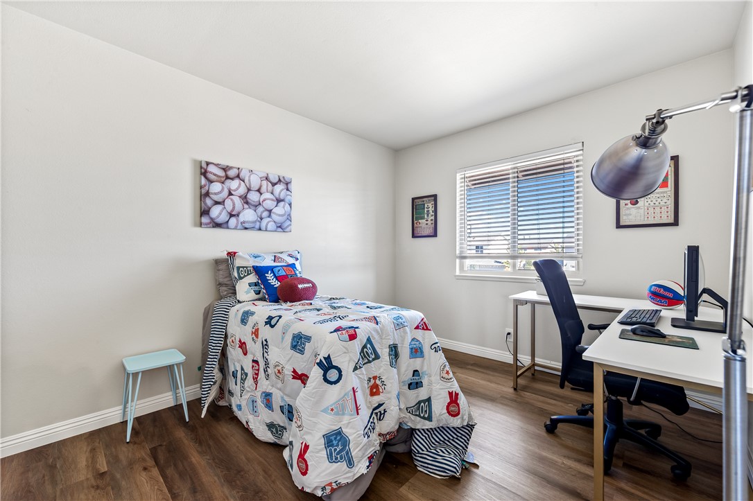 10191 Virgil Circle Cypress, CA 90630 - Photo 21 of 53 a bedroom with a bed and wooden floor