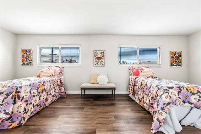 a bedroom with three beds and a window