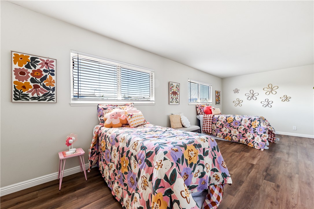 10191 Virgil Circle Cypress, CA 90630 - Photo 25 of 53 a bedroom with three beds and a window