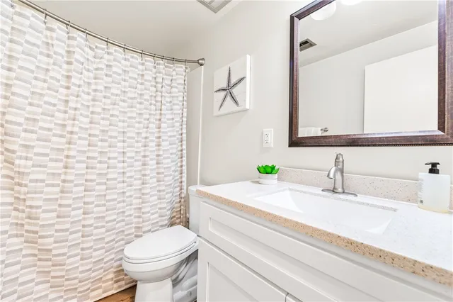 a bathroom with a sink vanity and a mirror