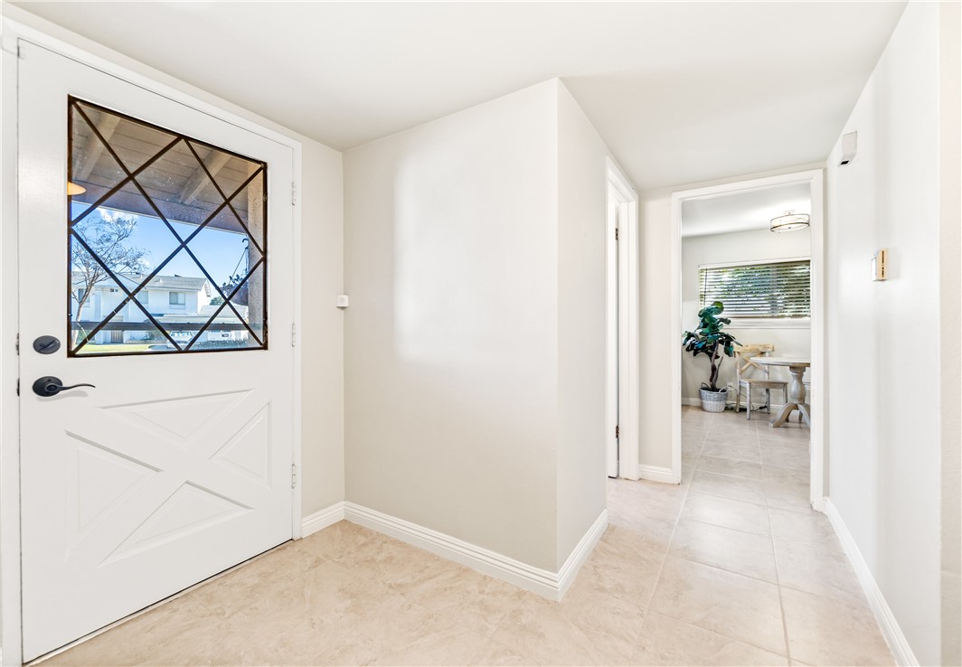 10191 Virgil Circle Cypress, CA 90630 - Photo 3 of 53 a view of a hallway with wooden floor and a living room