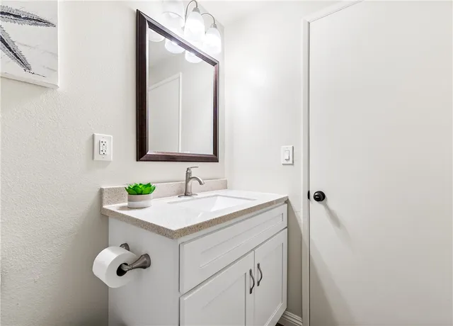 a view of a bedroom with wooden floor and furniture