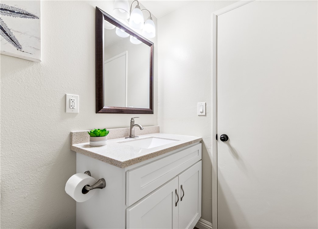 10191 Virgil Circle Cypress, CA 90630 - Photo 31 of 53 a bathroom with a sink vanity and a mirror