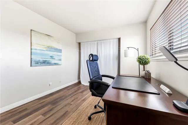 a view of a workspace with furniture and a potted plant