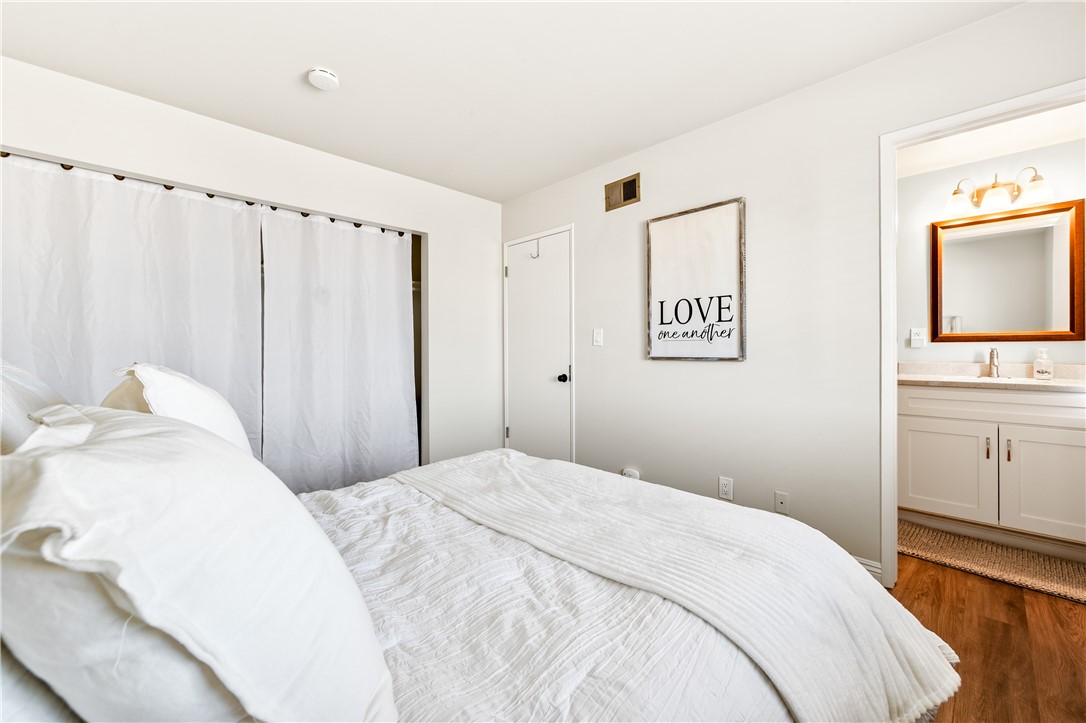 10191 Virgil Circle Cypress, CA 90630 - Photo 40 of 53 a bedroom with a bed and a flat tv screen on the dresser