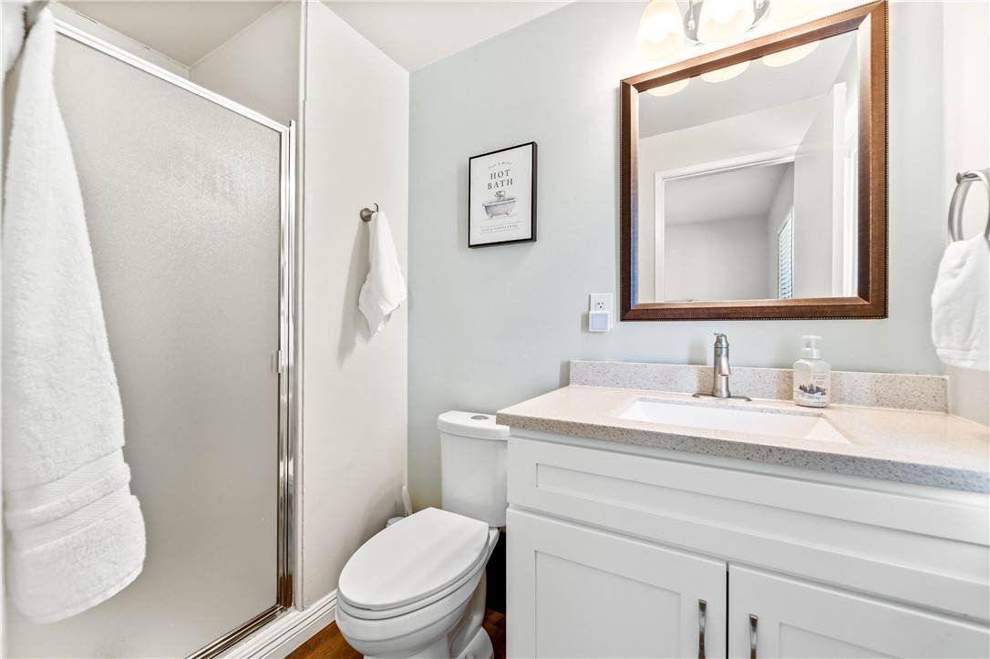 10191 Virgil Circle Cypress, CA 90630 - Photo 41 of 53 a bathroom with a toilet sink vanity and mirror
