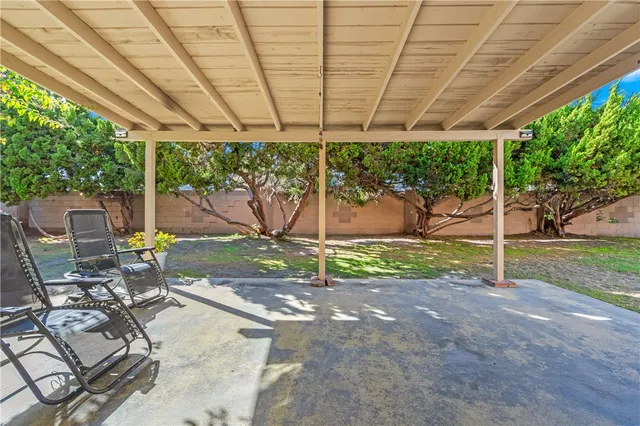 a view of a house with backyard and sitting area