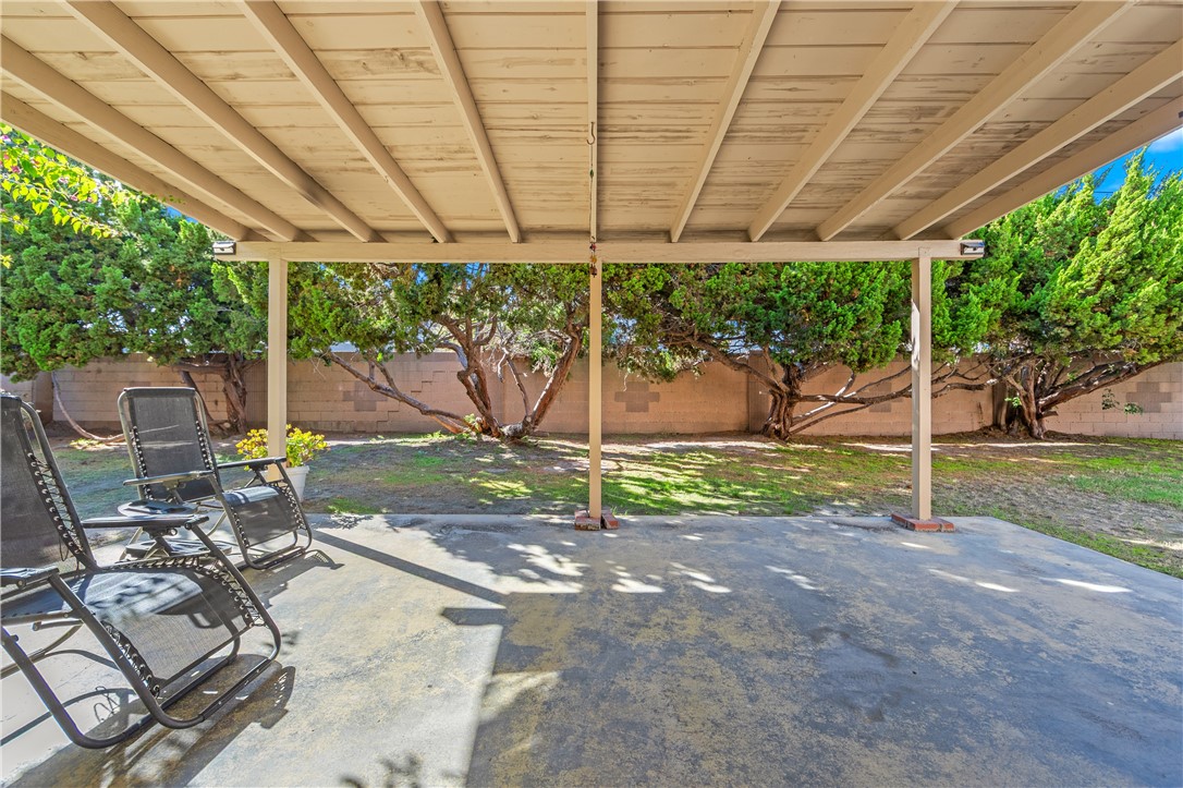 10191 Virgil Circle Cypress, CA 90630 - Photo 44 of 53 a view of a patio with table and chairs a barbeque with wooden fence