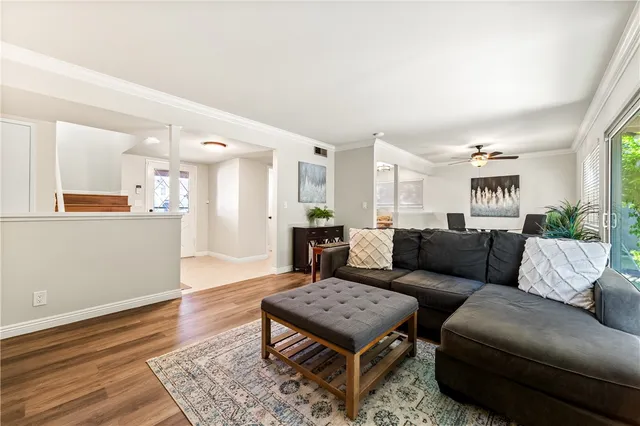 a living room with furniture and wooden floor