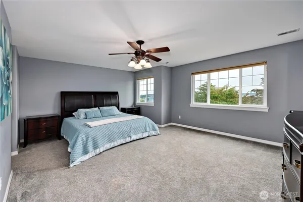 a bedroom with a bed and a ceiling fan
