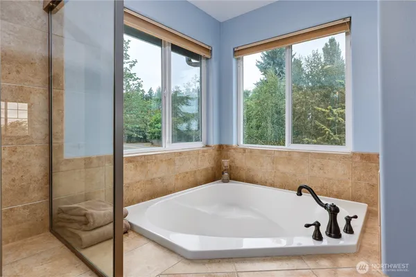 a bath tub sitting in a bathroom next to a window