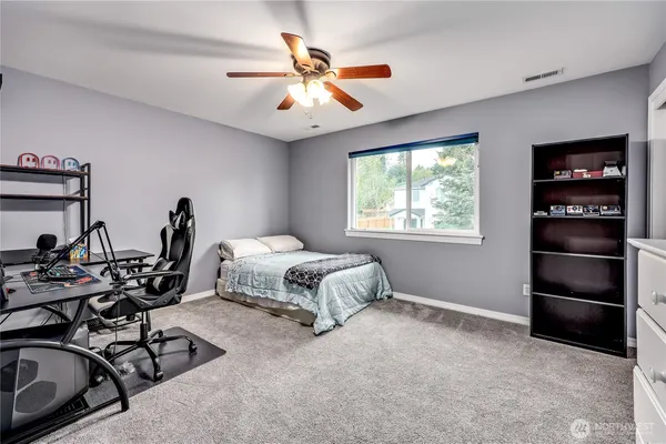 a spacious bedroom with a bed and a window