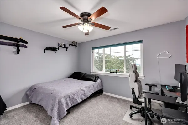 a bedroom with a bed and a large window