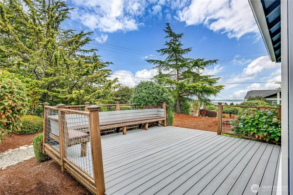 a view of a terrace with wooden floor and a bench