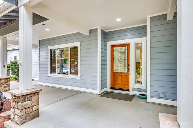a kitchen with stainless steel appliances kitchen island granite countertop wooden floors and white cabinets