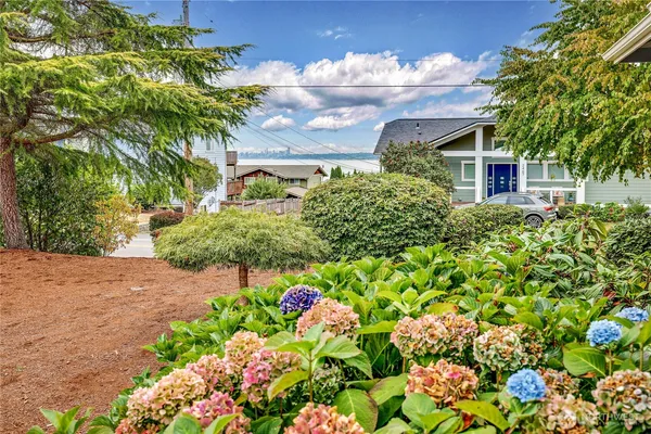 a front view of a house with a yard and a garage