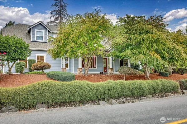 a front view of a house with garden