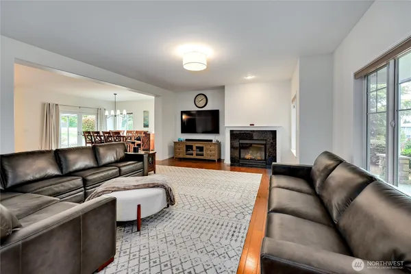 a living room with furniture flat screen tv and a fireplace