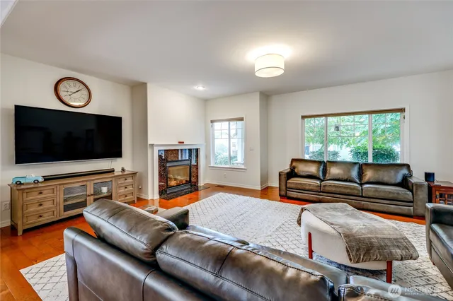 a living room with furniture flat screen tv and a fireplace