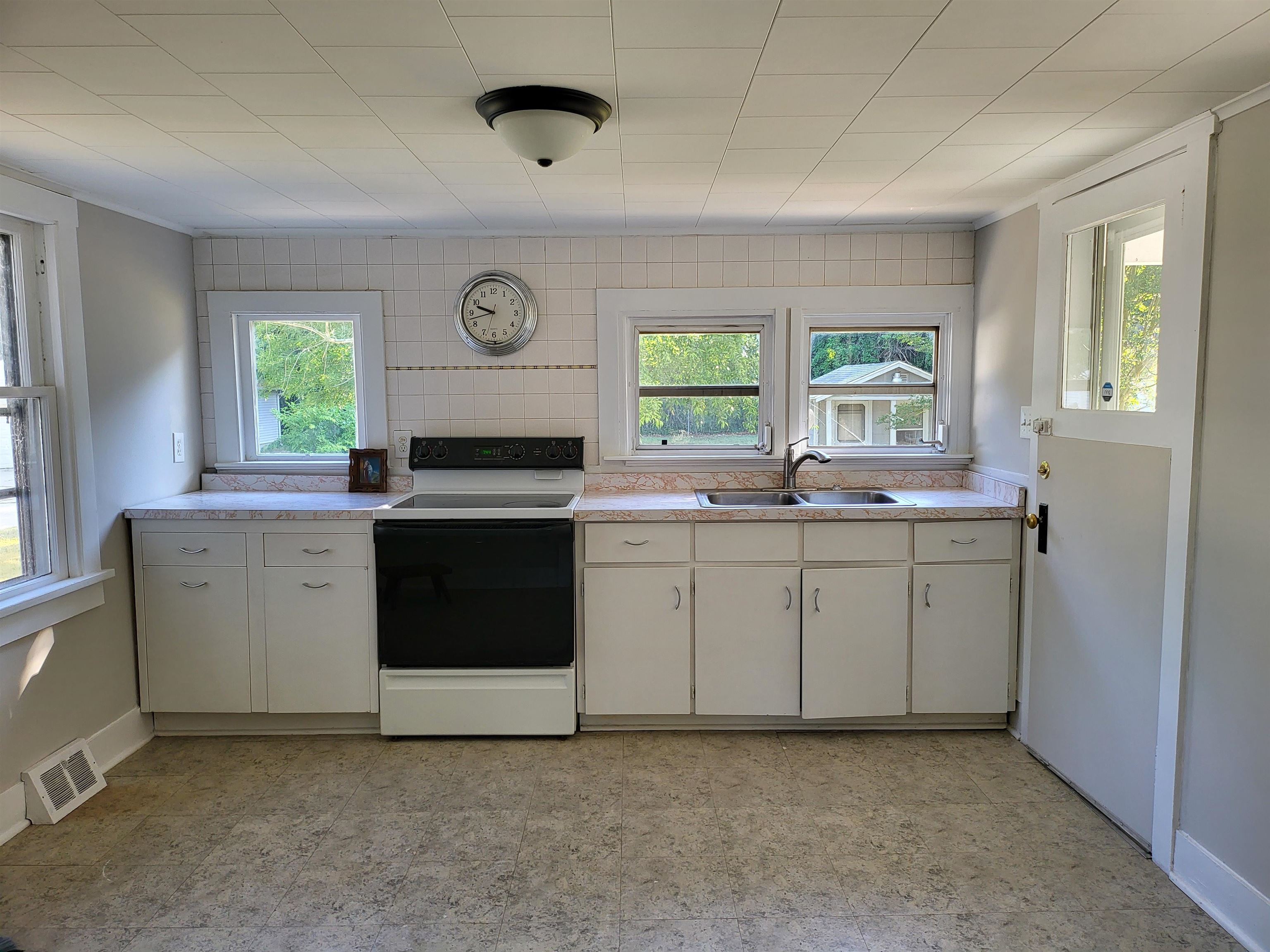 611 Breakwater Road Erma, NJ 08204 - Photo 5 of 12 a kitchen with white cabinets and white appliances