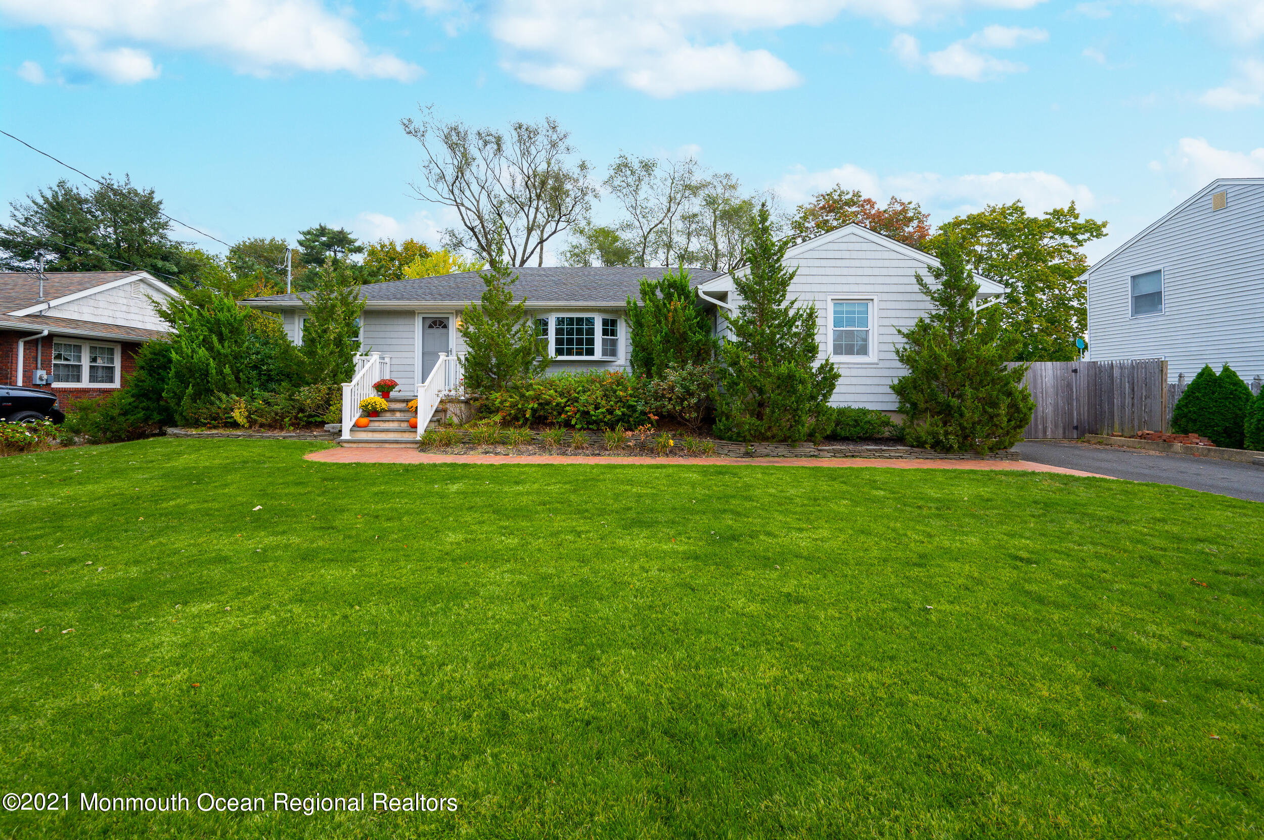 314 Sudbury Road Point Pleasant, NJ 08742 - Photo 2 of 21 a front view of a house with a yard table and chairs
